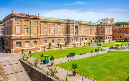 Vatican Museums exterior with green lawn, part of small-group guided tour.