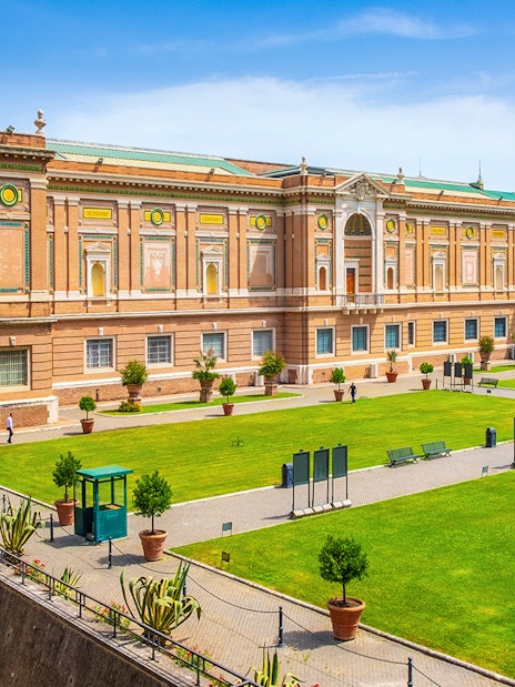 Vatican Museums exterior with green lawn, part of small-group guided tour.