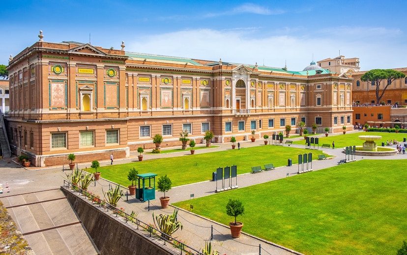 Vatican Museums exterior with green lawn, part of small-group guided tour.