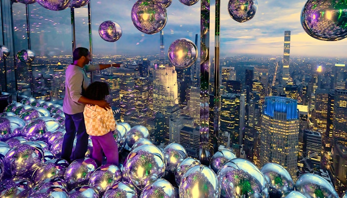 Father and daughter enjoying skyline view at Summit One Vanderbilt, New York City.