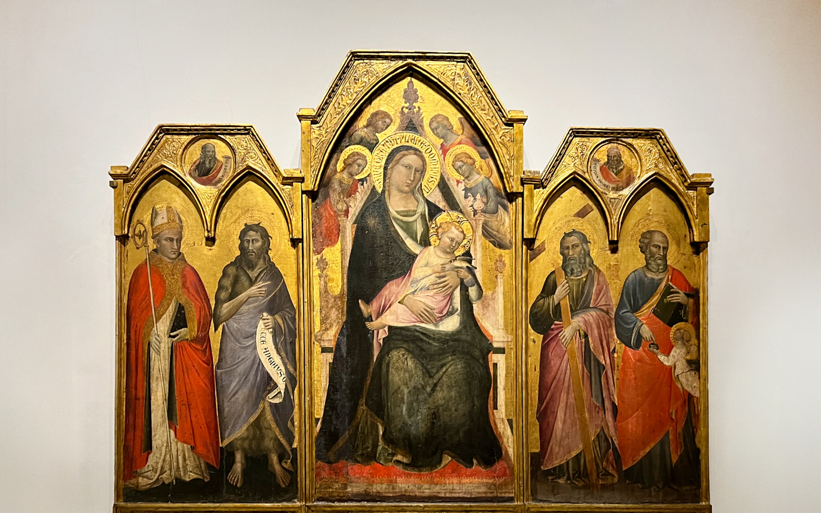 The Enthroned Madonna and Child with Saints by Agnolo Gaddi, featuring religious figures.