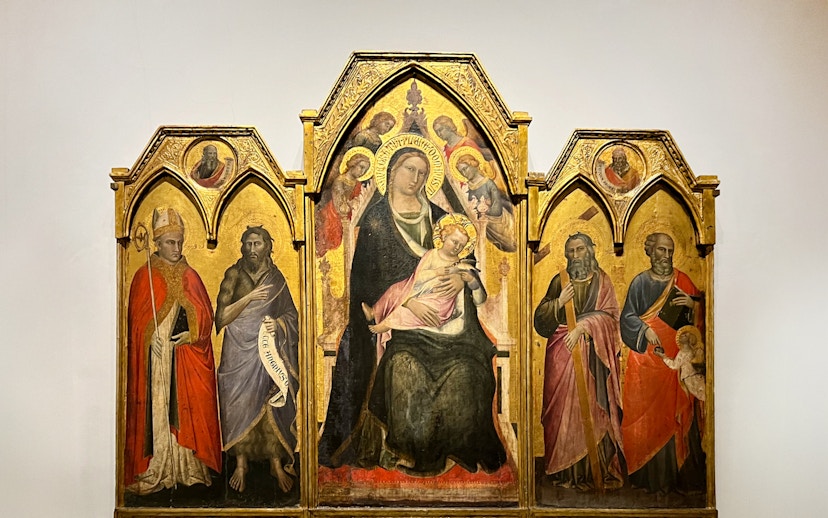 The Enthroned Madonna and Child with Saints by Agnolo Gaddi, featuring religious figures.