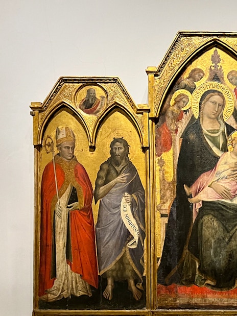 The Enthroned Madonna and Child with Saints by Agnolo Gaddi, featuring religious figures.