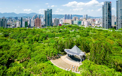 Aerial view of Daan Forest Park amphitheater and Taipei city skyline, Taiwan.