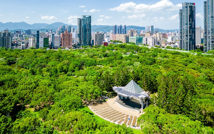 Aerial view of Daan Forest Park amphitheater and Taipei city skyline, Taiwan.