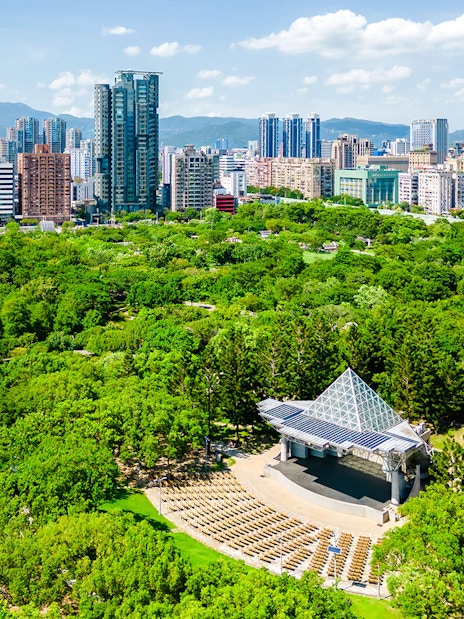 Aerial view of Daan Forest Park amphitheater and Taipei city skyline, Taiwan.