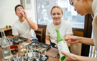 Pouring sake at Kyoto Insider Sake Experience tasting session.