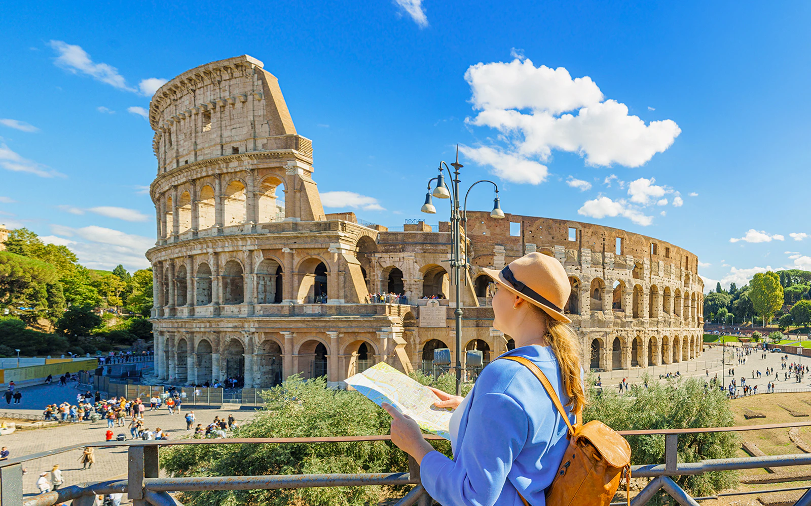 Tourist with map near Colosseum entrance in Rome.