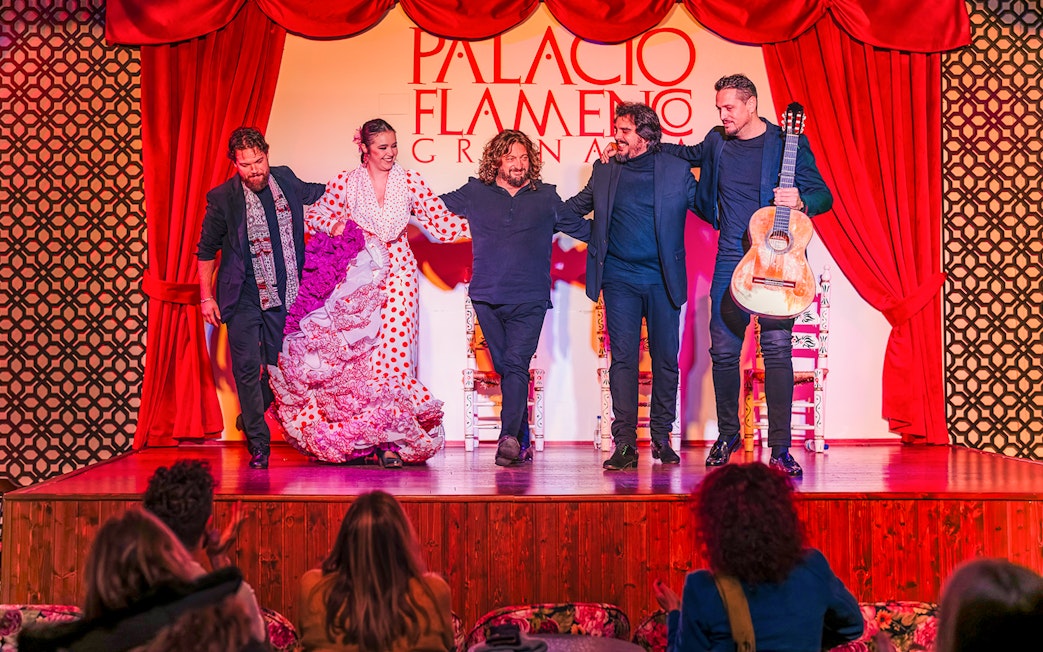 Flamenco dancers and musicians on stage at Palacio Flamenco Granada show.