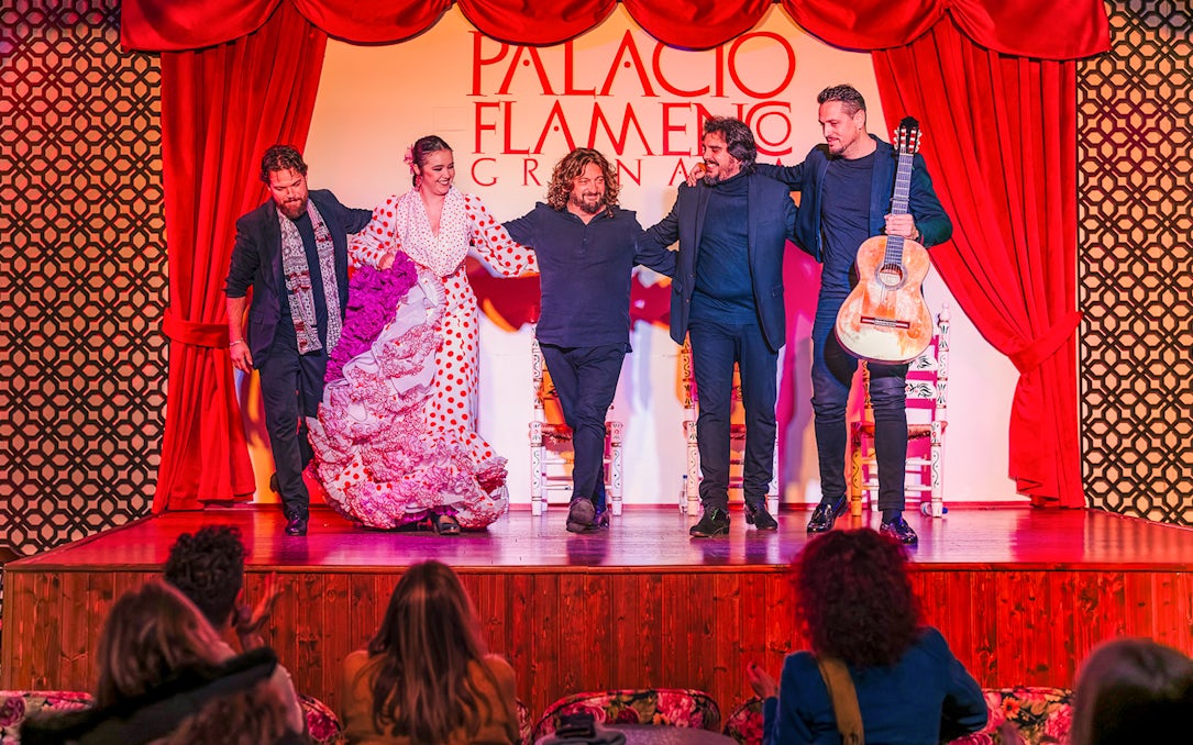 Flamenco dancers and musicians on stage at Palacio Flamenco Granada show.
