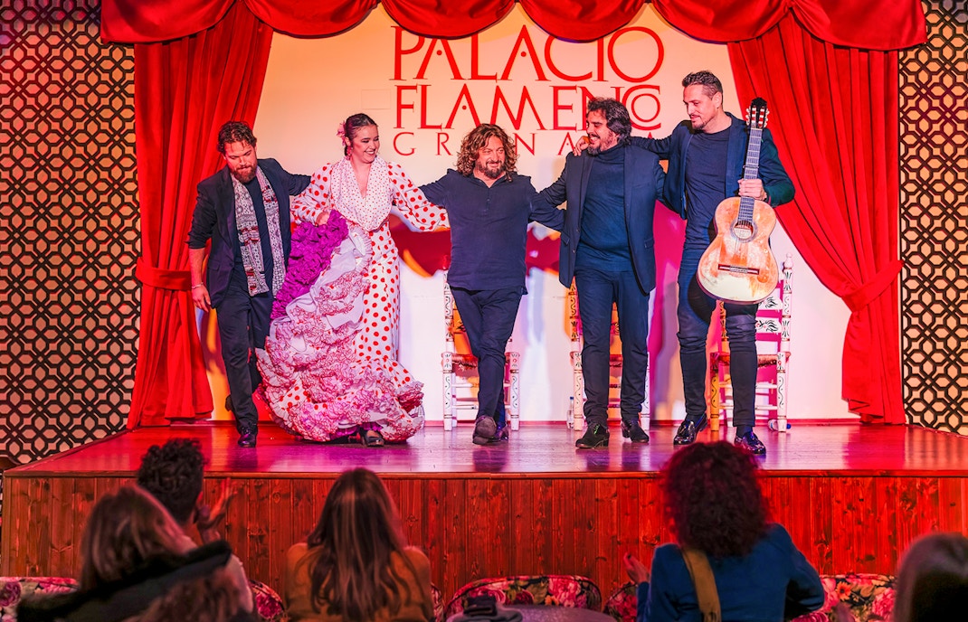 Flamenco dancers and musicians on stage at Palacio Flamenco Granada show.