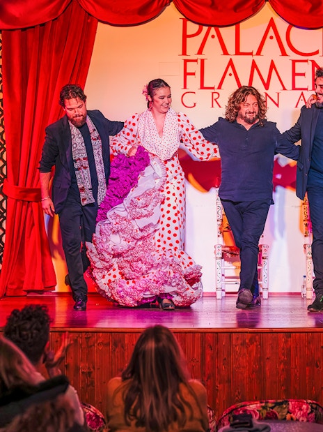Flamenco dancers and musicians on stage at Palacio Flamenco Granada show.