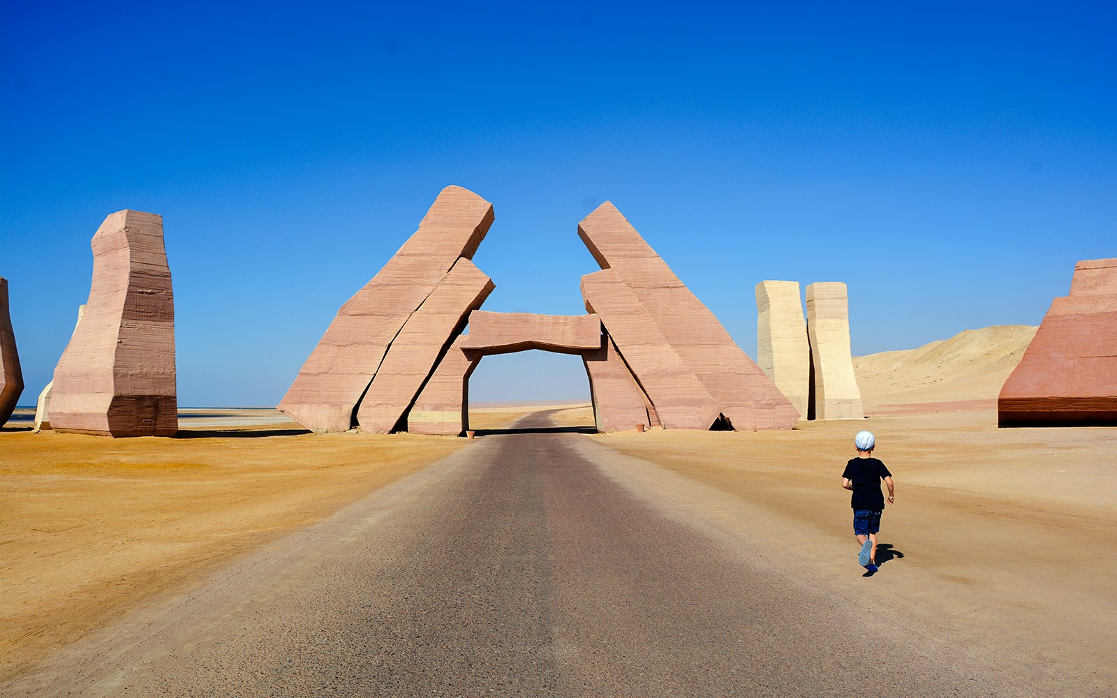 Allah's Gate entrance at Ras Mohammed National Park, Egypt, with a child walking on the road.