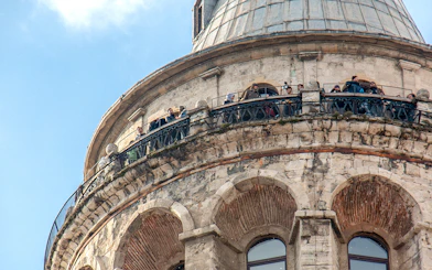 Visitors on the balcony of Galata Tower, Istanbul, viewing the cityscape.
