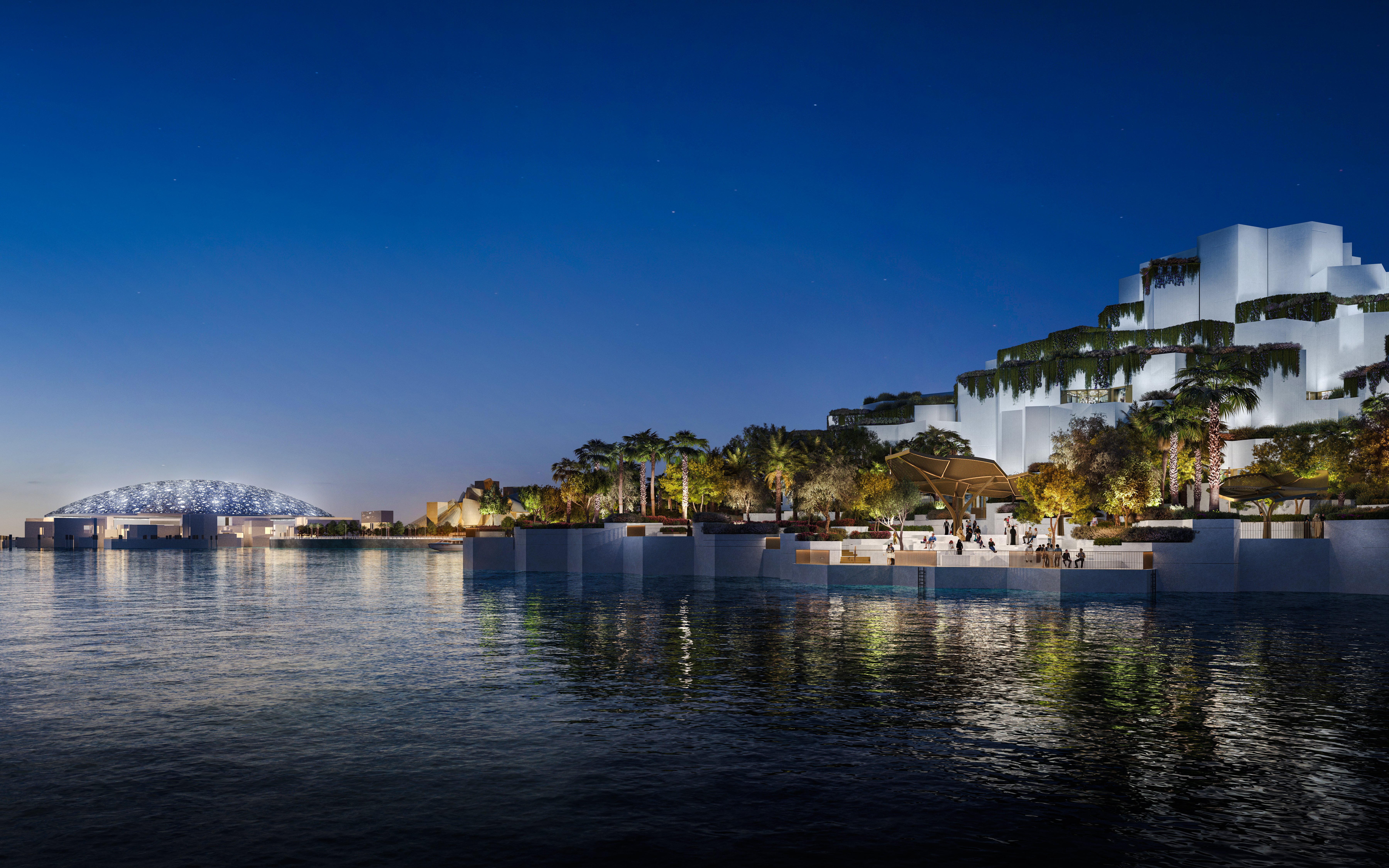 Aerial view of the National History Museum Abu Dhabi illuminated at night.