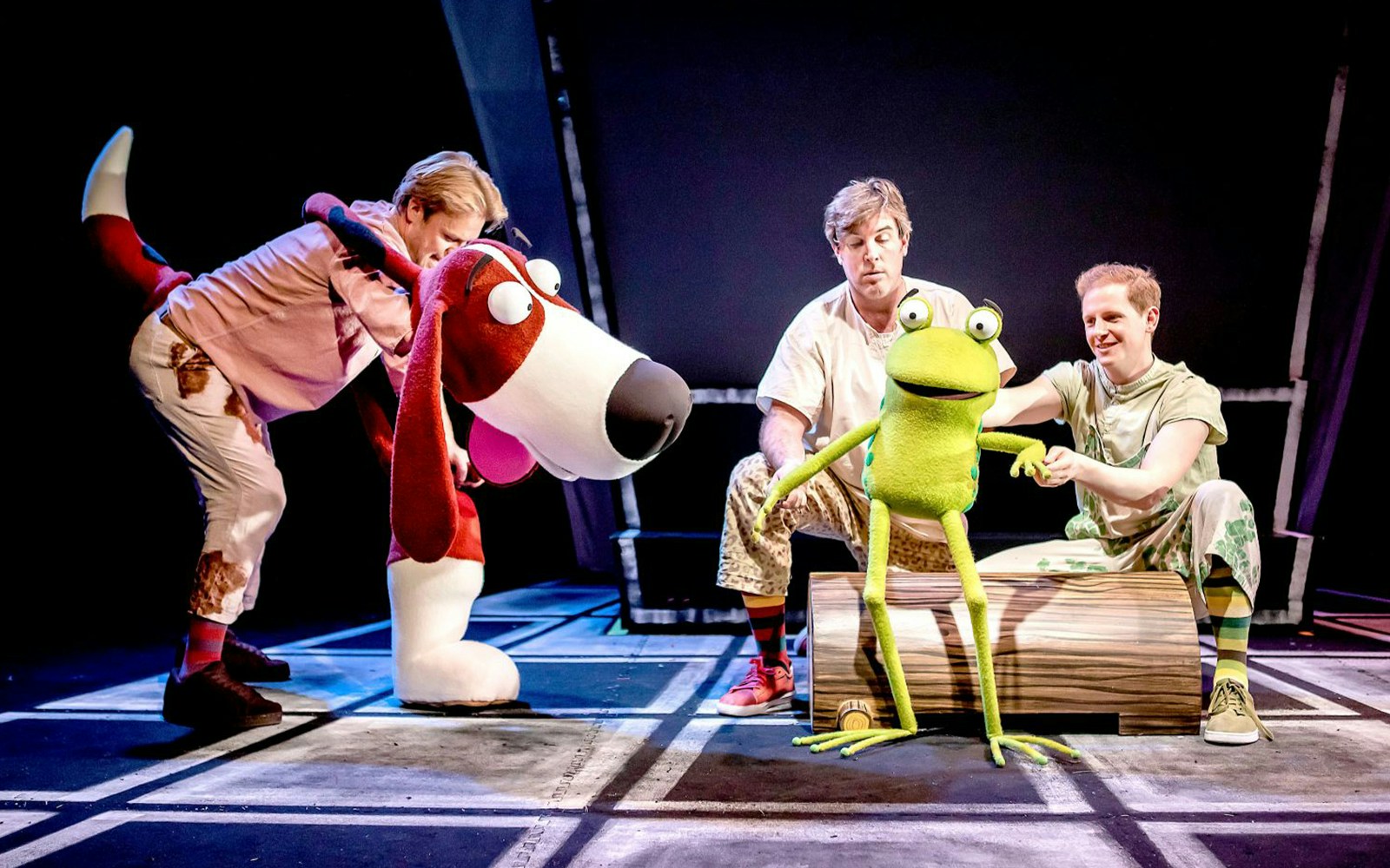 Actors performing with frog and dog puppets in "Oi Frog & Friends!" show.