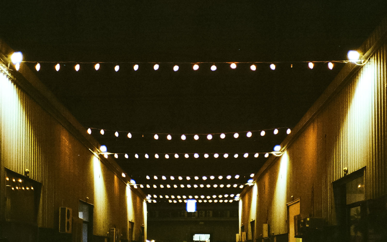 String lights illuminating Alserkal Avenue at night.
