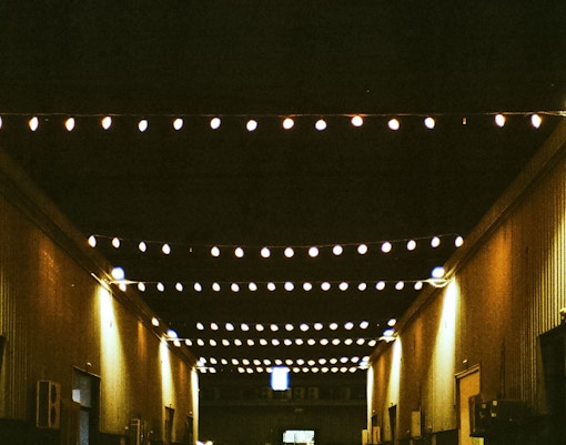 String lights illuminating Alserkal Avenue at night.