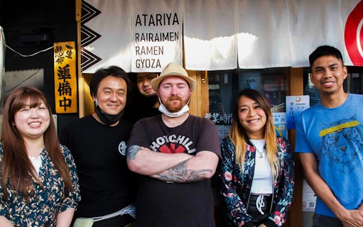 Group of people outside a ramen restaurant in Japan for a Ramen Kitchen Experience.