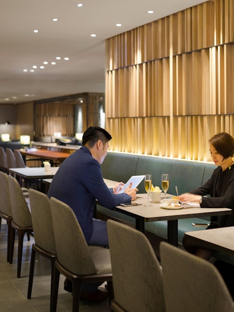 Guests working at a table in Plaza Premium Lounge, Zone C, Taipei, Taiwan.