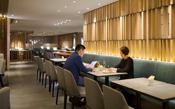Guests working at a table in Plaza Premium Lounge, Zone C, Taipei, Taiwan.