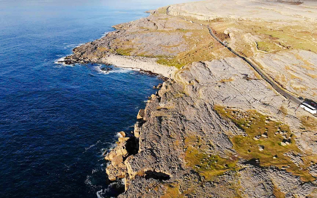 Aerial view of rocky coastline at The Burren, Ireland, meeting the Atlantic Ocean.
