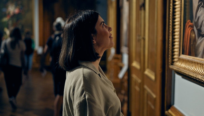 Visitor admiring paintings at an art museum
