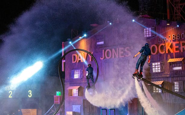 Performers on water jetpacks at Global Village carnival show.