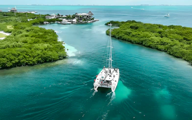 Catamaran sailing through turquoise waters from Cancun to Isla Mujeres.