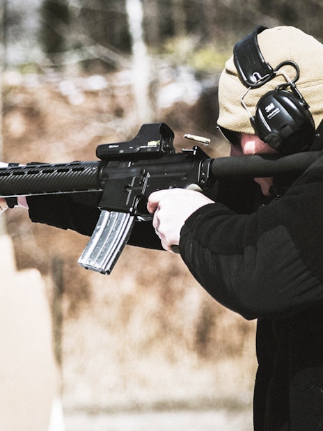 Person aiming rifle at targets at a shooting range in Krakow.