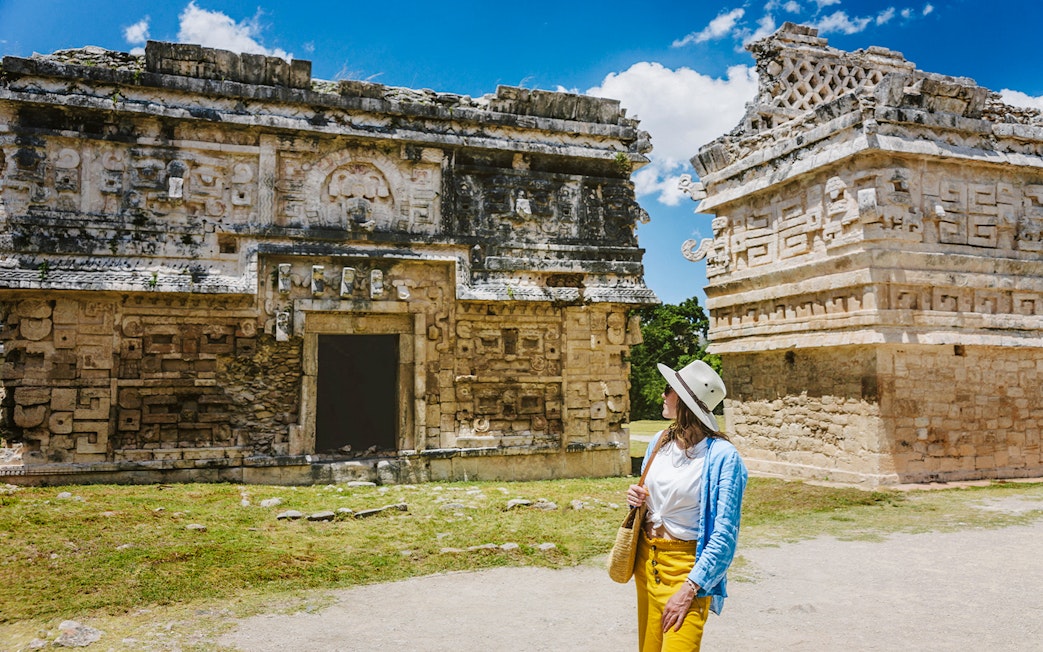 Tourist exploring ancient ruins at Chichen Itza, Yucatan.
