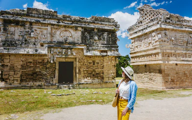 Tourist exploring ancient ruins at Chichen Itza, Yucatan.
