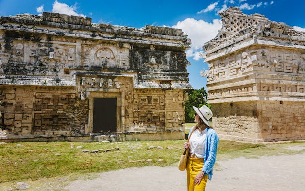 Tourist exploring ancient ruins at Chichen Itza, Yucatan.