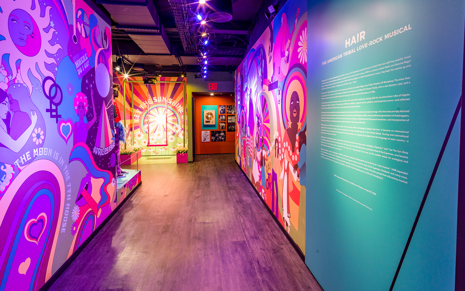 Colorful hallway with vibrant murals and text about the musical "Hair" at The Museum Of Broadway.