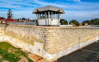 Watch tower at Fremantle Prison, historic stone walls, and surrounding landscape.