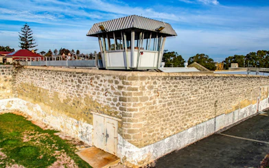Watch tower at Fremantle Prison, historic stone walls, and surrounding landscape.