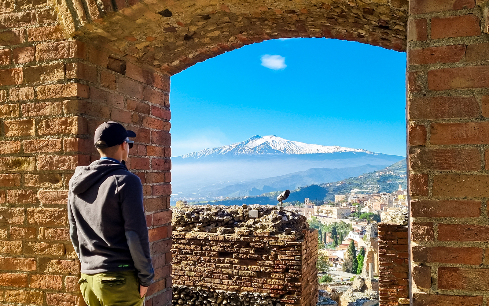Man looking at Mount Etna from Taormina theatre