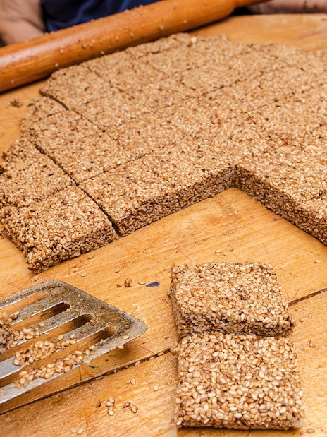 Melekouni sesame squares being prepared on a wooden board, Rhodes Island.