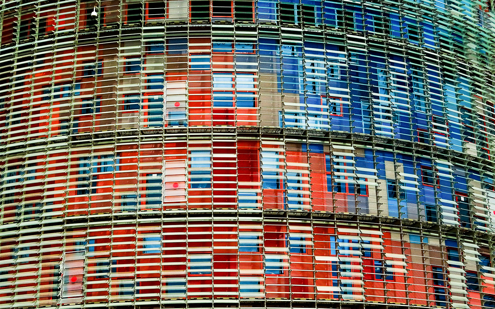 Facade of Torre Glories in Barcelona with colorful glass panels.