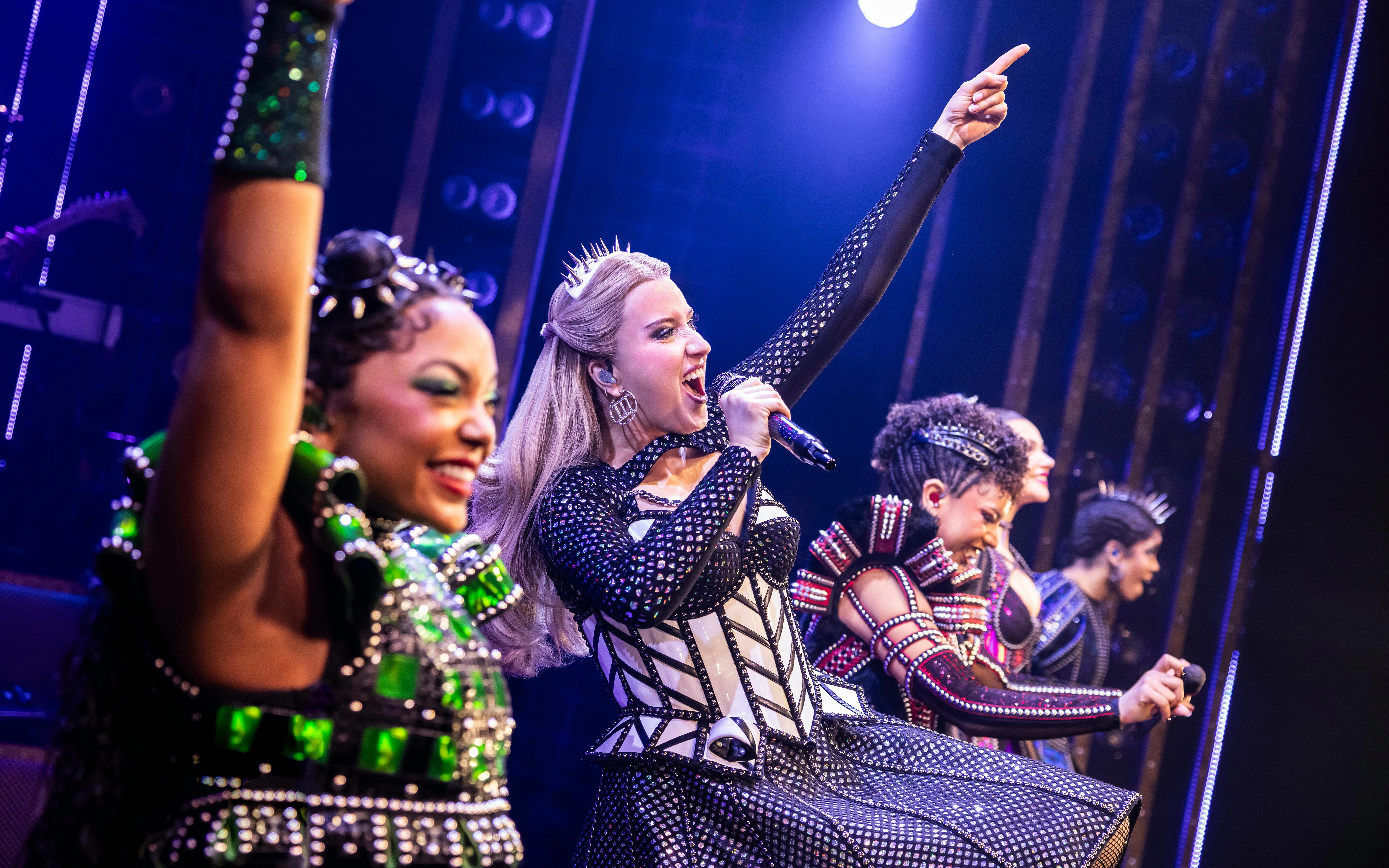 Performers singing on stage during Six musical in West End.