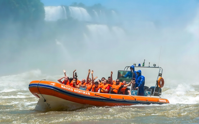 Tourists on a boat near Iguazú Falls, Brazilian side, enjoying the view.