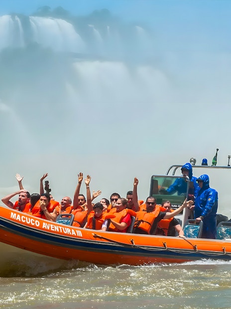 Tourists on a boat near Iguazú Falls, Brazilian side, enjoying the view.
