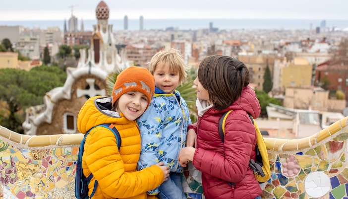 Family enjoying terrace view at Park Guell, Barcelona.