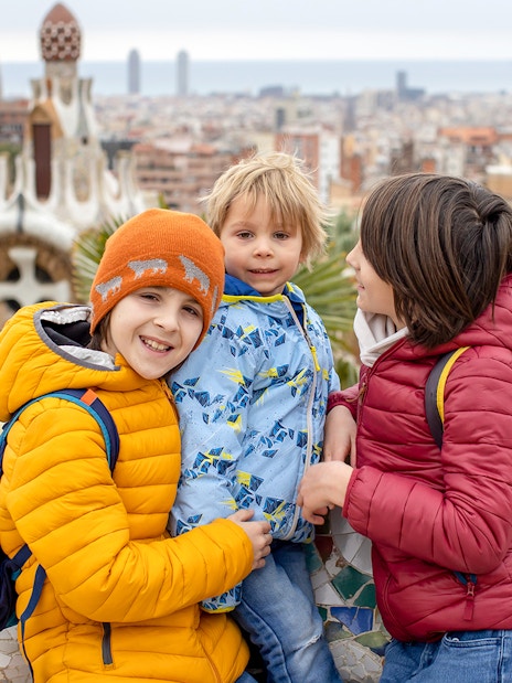 Family enjoying view from Park Güell terrace, Barcelona.