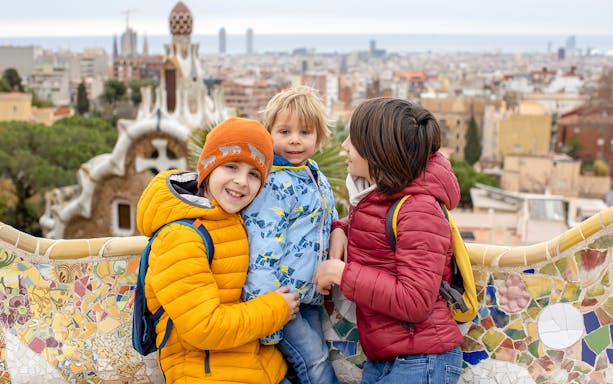 Family enjoying view from Park Güell terrace, Barcelona.