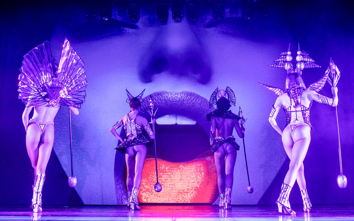 Performers in futuristic costumes on stage at Paradis Latin show.