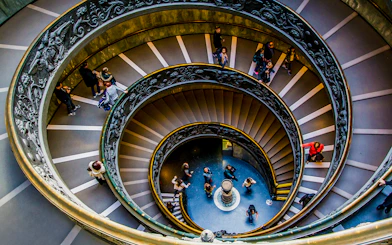 Tourists on the spiral staircase in Vatican Museums, part of the Sistine Chapel tour.