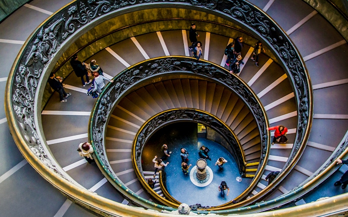 Tourists on the spiral staircase in Vatican Museums, part of the Sistine Chapel tour.