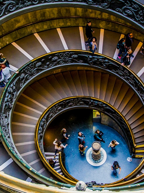 Tourists on the spiral staircase in Vatican Museums, part of the Sistine Chapel tour.
