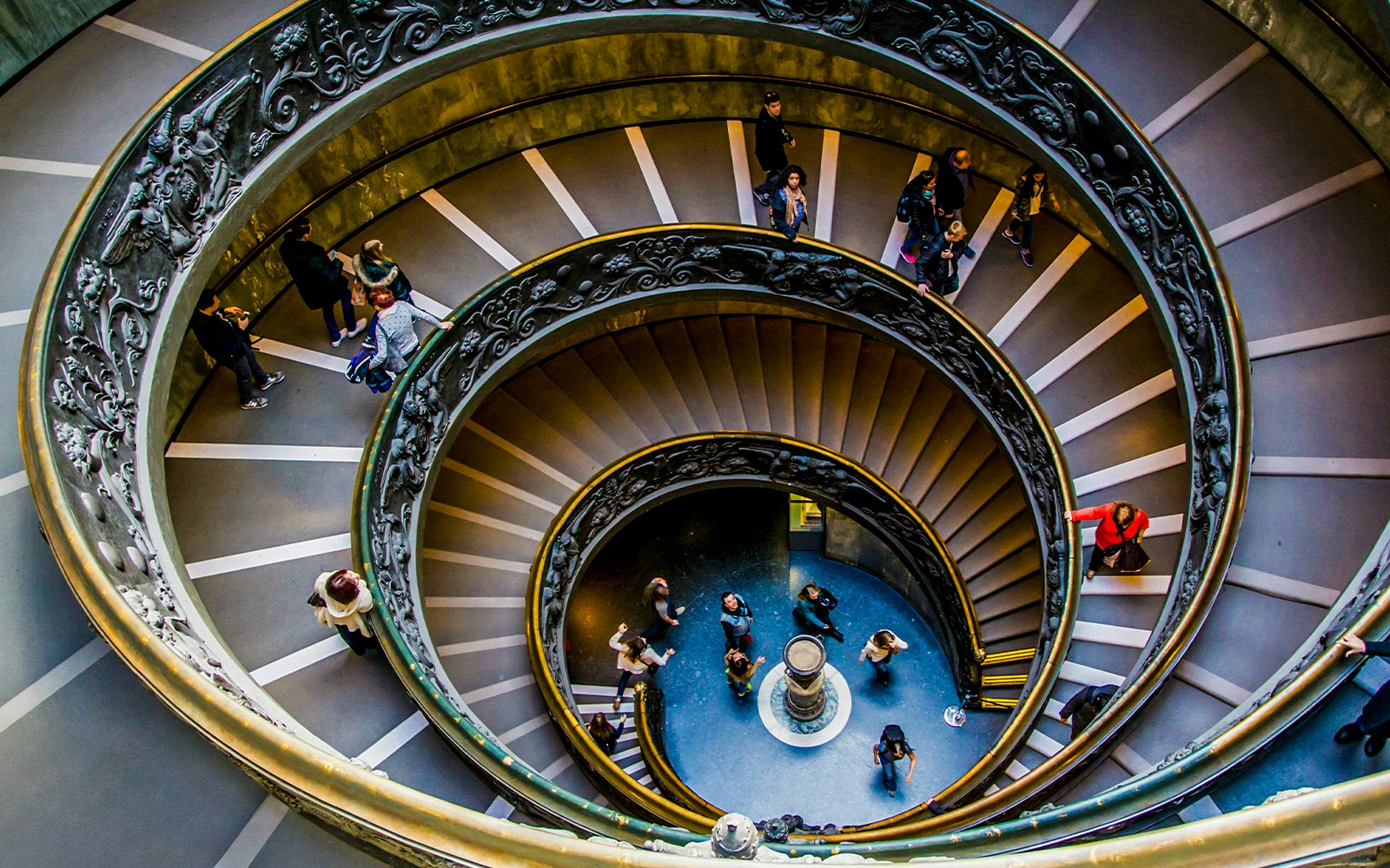 Tourists on spiral staircase in Vatican Museums, part of Sistine Chapel Tickets tour.